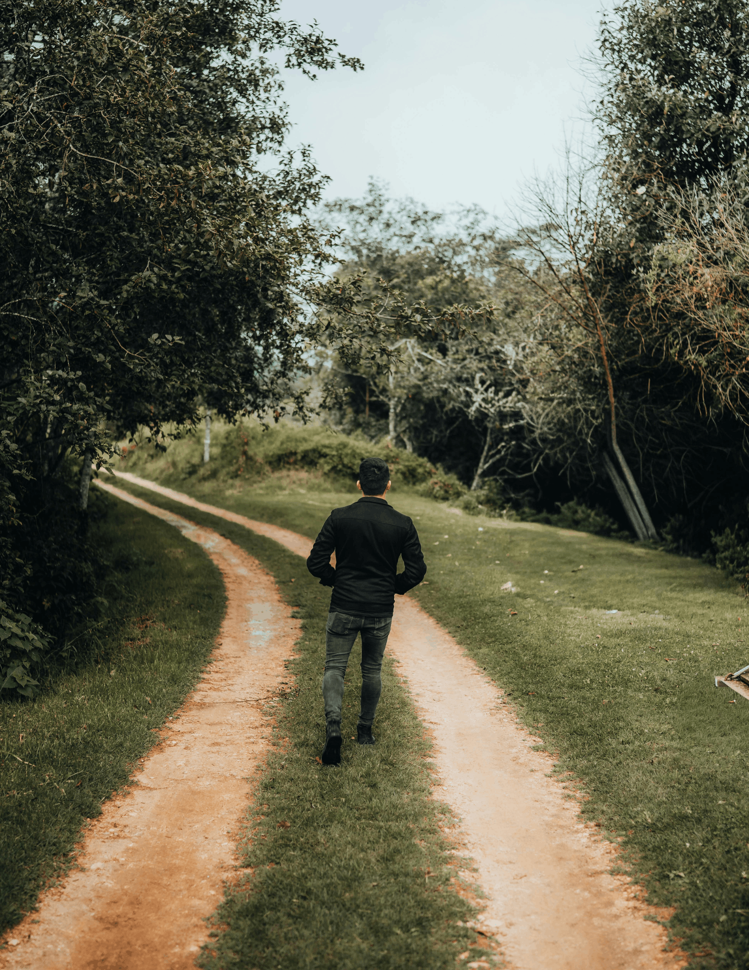 Man walking down dirt path