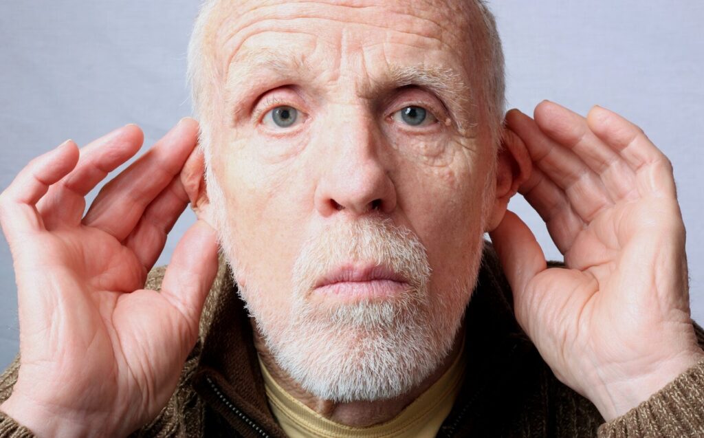 a man with a beard listening in